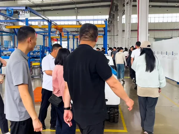 Students observing intelligent equipment production line